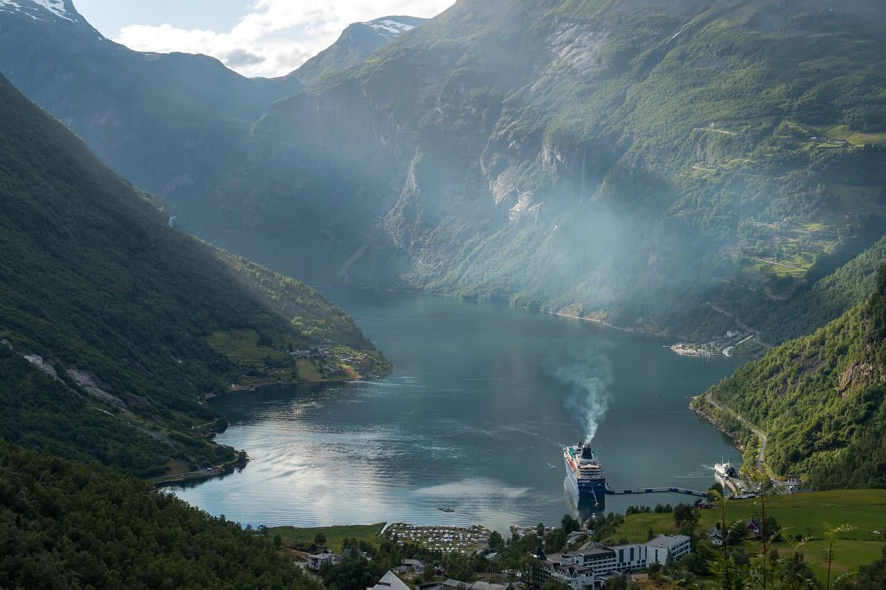 Aerial view of small Norwegian farming village perched on cliffs above Geirangerfjord