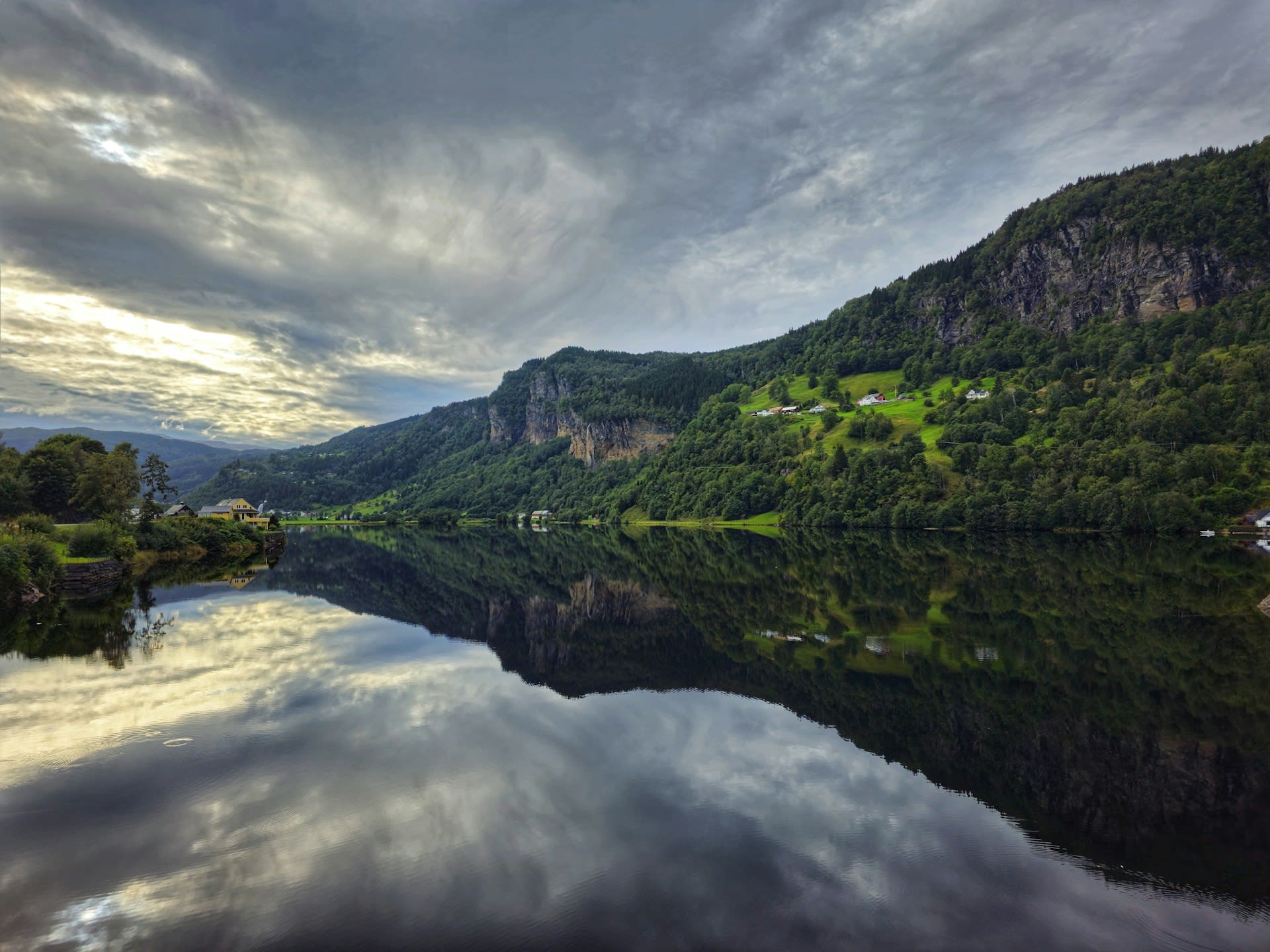 Hardangerfjord spring blossom with fruit orchards and Folgefonna glacier above the deep blue fjord Norway