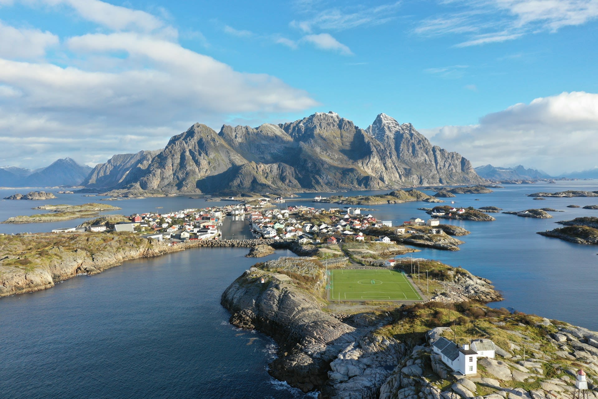 Traditional red and yellow rorbu fishing cabins on stilts over the water at Lofoten, Norway
