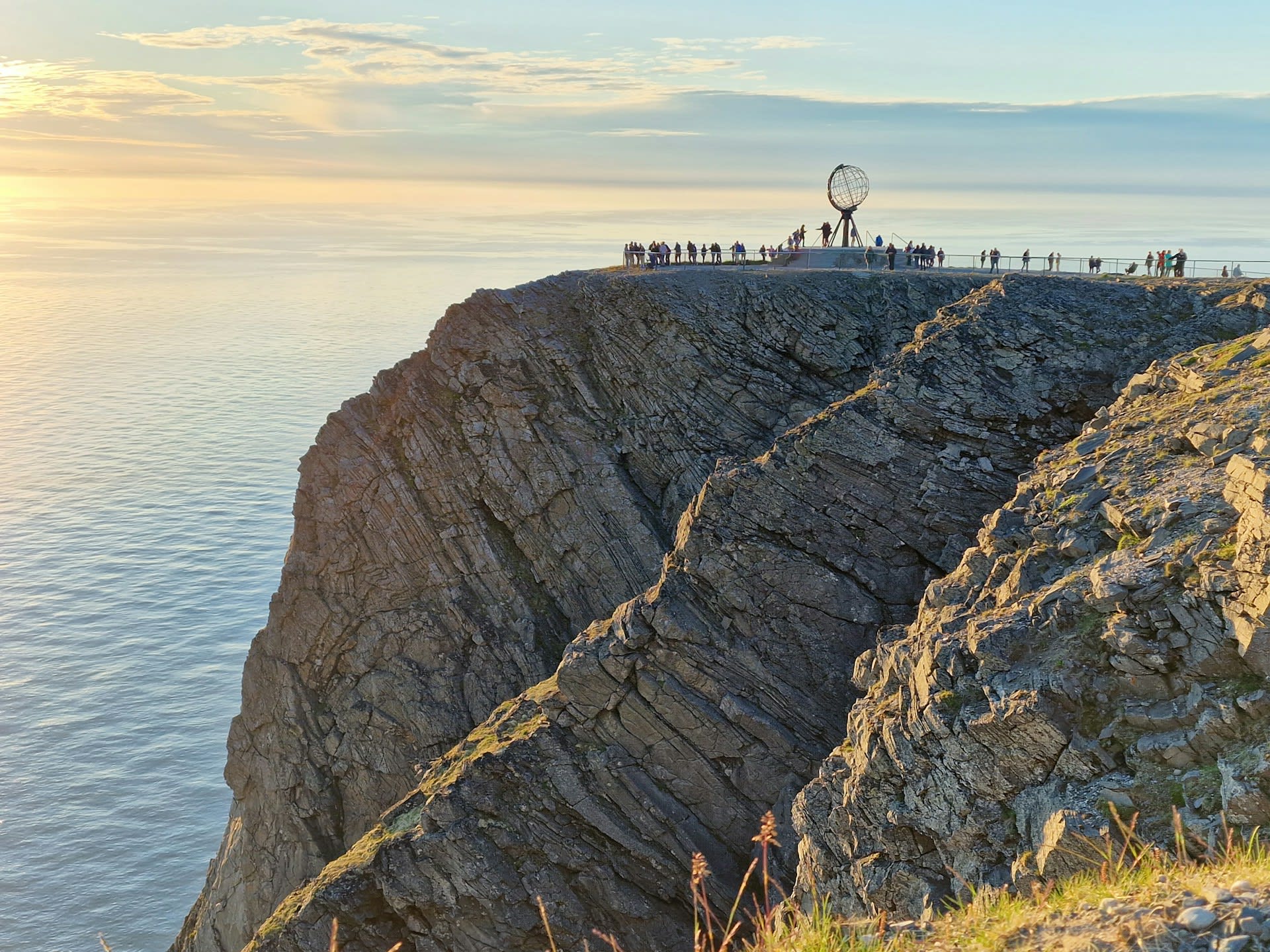 Midnight sun hovering above the Arctic Ocean horizon at North Cape, Nordkapp Norway