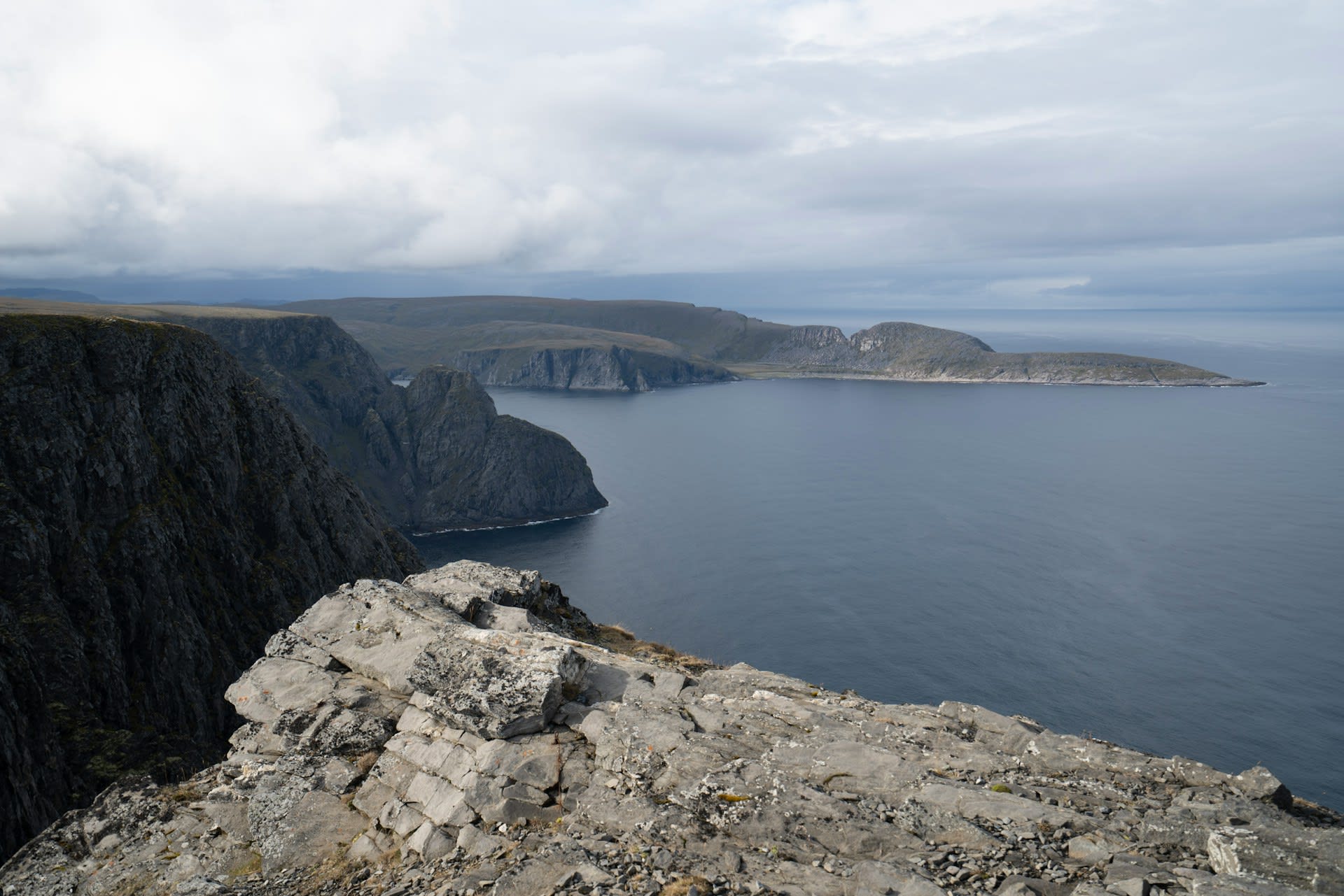 Globe sculpture monument on the cliff edge of Nordkapp with the Barents Sea behind