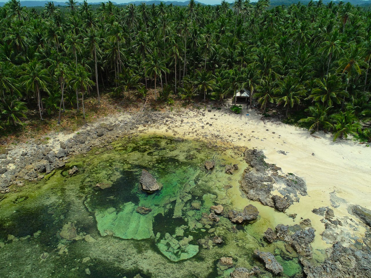 Magpupungko tidal rock pools at low tide on Siargao Island Philippines with clear ocean water