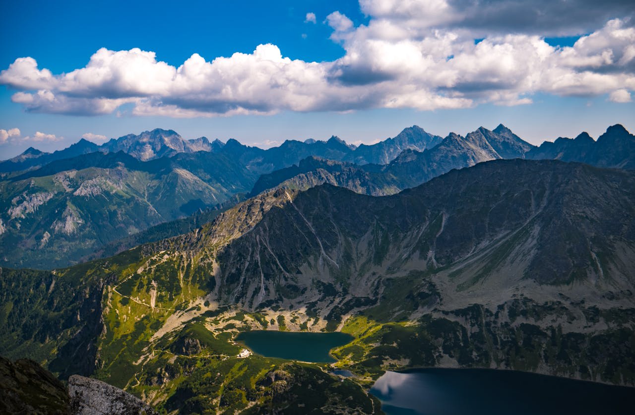 Alpine meadow of the High Tatras with jagged rocky ridgeline against a blue sky in southern Poland