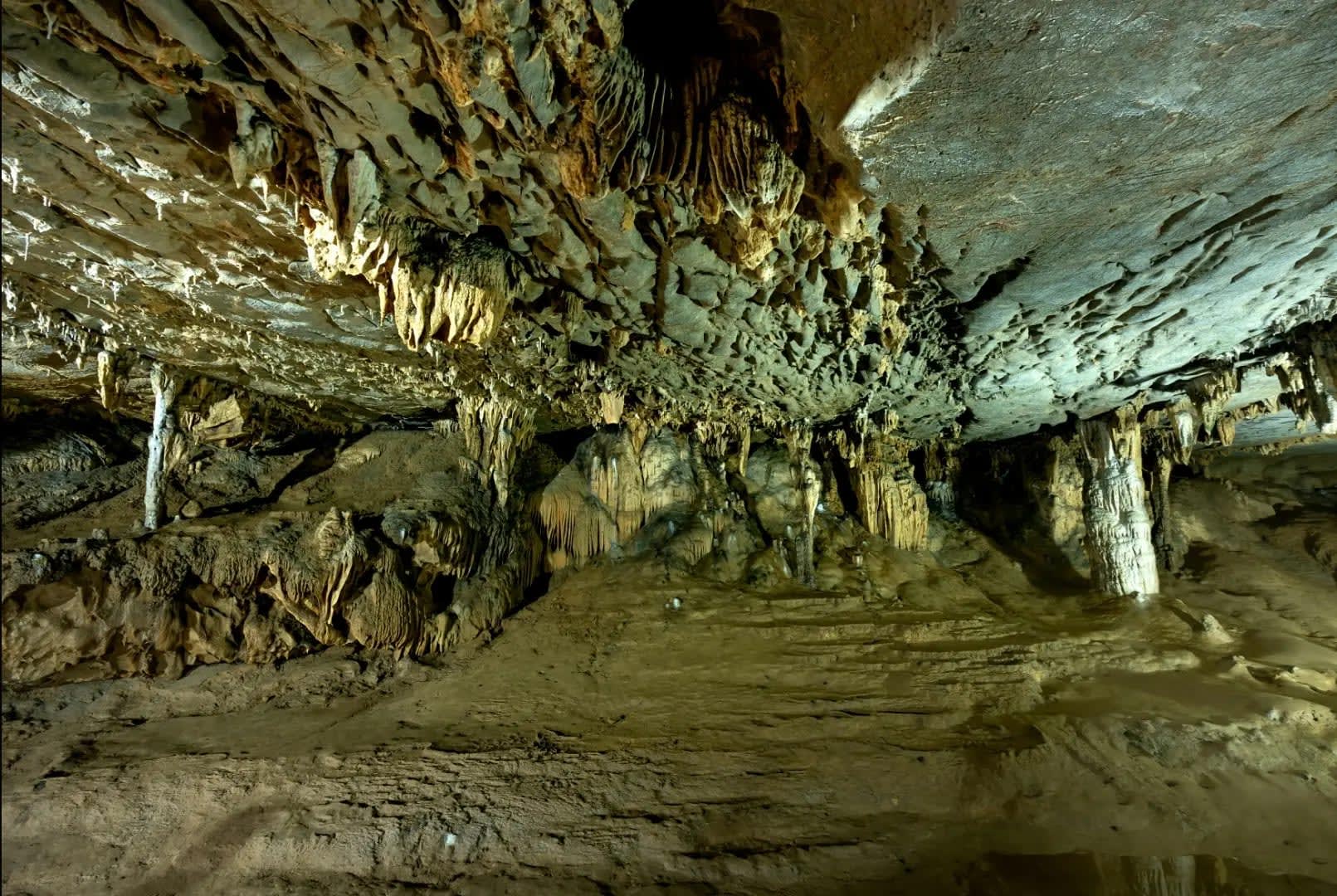 Interior view of Cueva Ventana highlighting the rugged, irregular walls adorned with natural rock formations, creating an intriguing texture and ambiance within the cave.