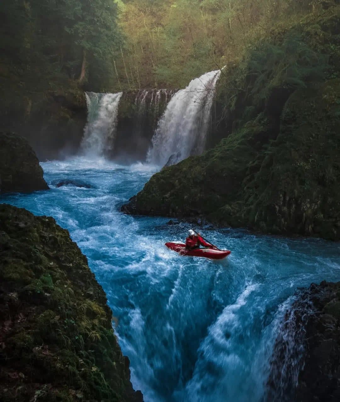 Two waterfalls surrounded by vegetation with a person in a kayak, Chutes Boyoma