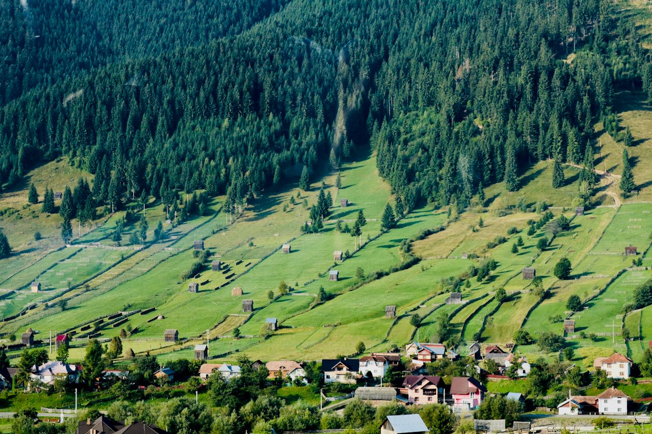Medieval village surrounded by Carpathian forest and mountain ridges in Transylvania Romania