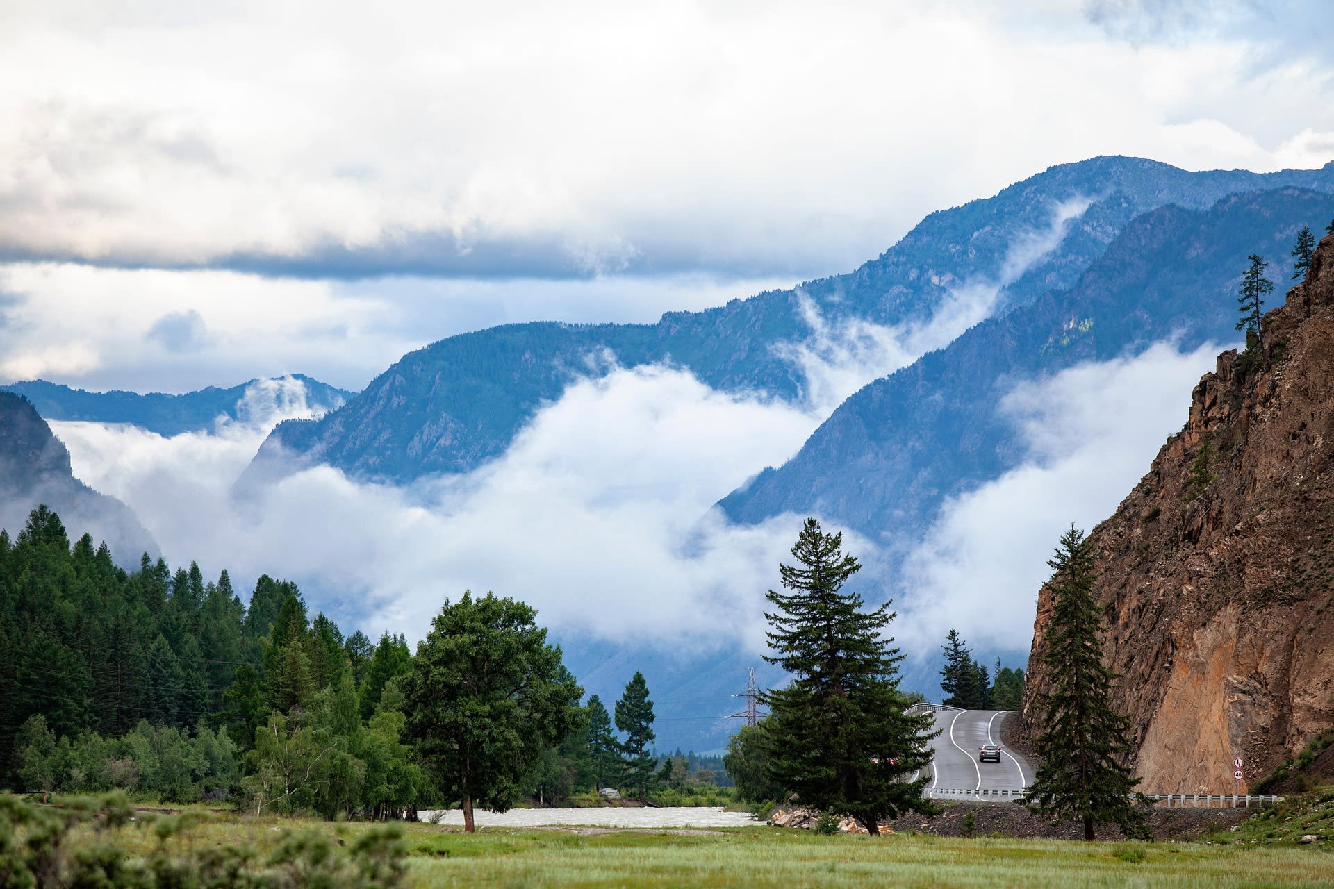 Winding mountain road through the forested ridges of the Altai, Russia