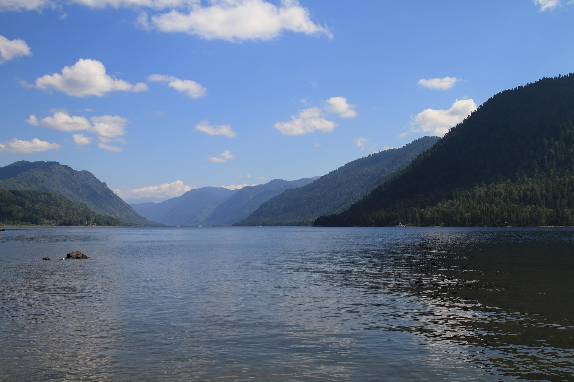 Forested mountains and waterfall at the southern end of Lake Teletskoye, Altai Russia