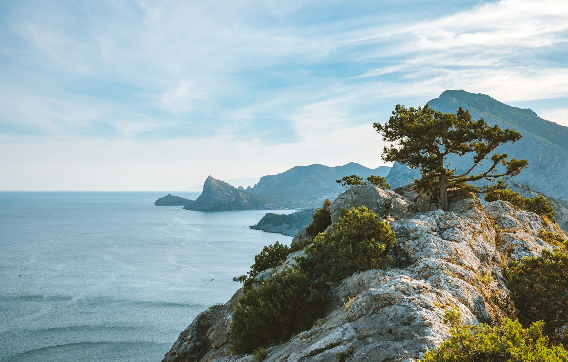 Rocky coastal path above the sea with views of the Sudak cliffs, Crimea