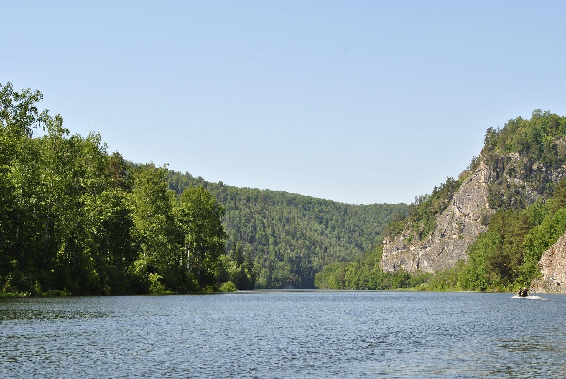 Forested ridges of the Ural Mountains reflected in a river, European-Asian boundary Russia