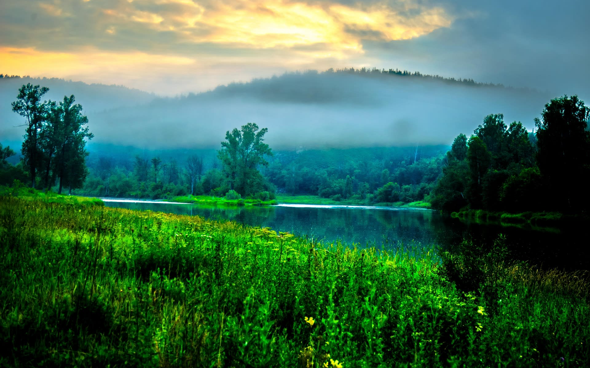 Morning mist rising over the forested Ural Mountains in autumn, Russia
