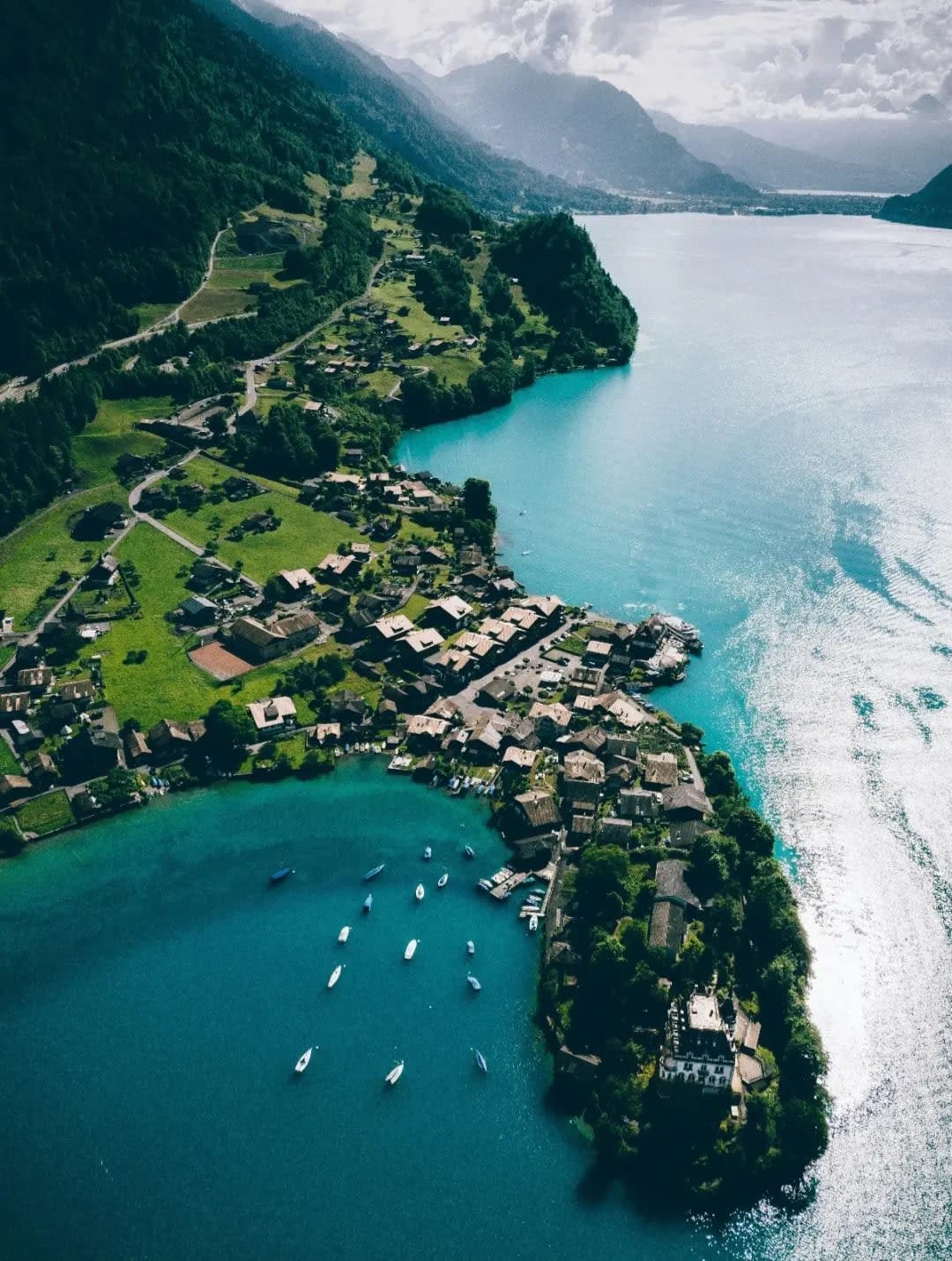 aerial view of a village nestled between mountain ranges and facing a lake, Interlaken