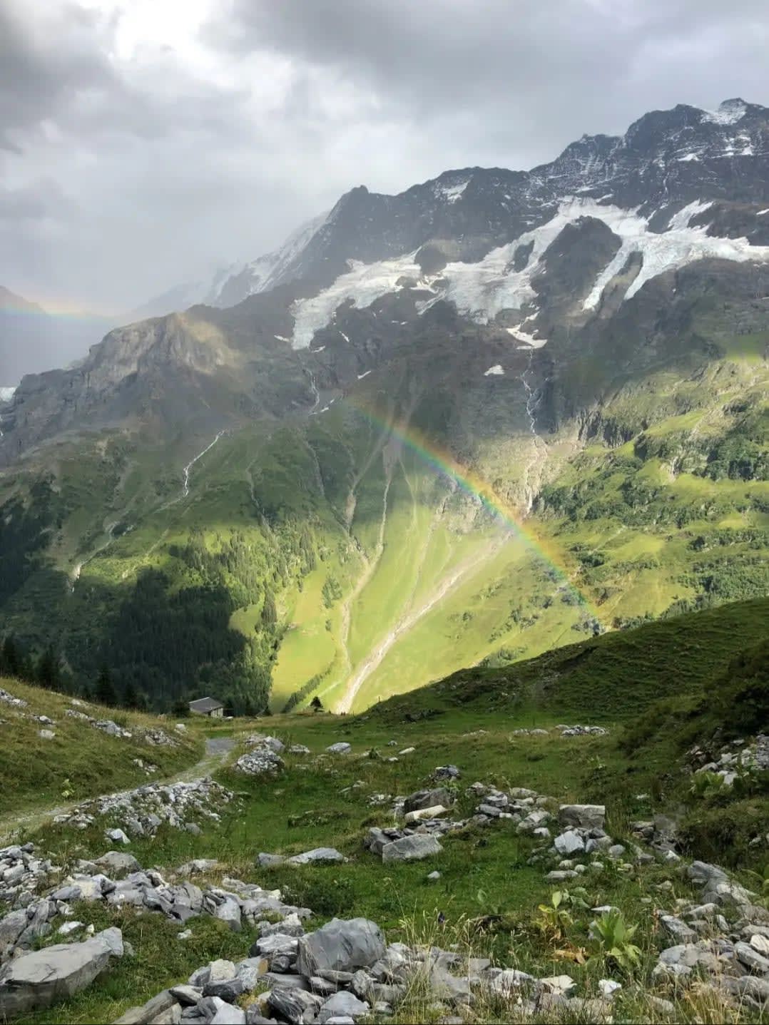 mountain with rocks, vegetation, and a rainbow ,Lauterbrunnental
