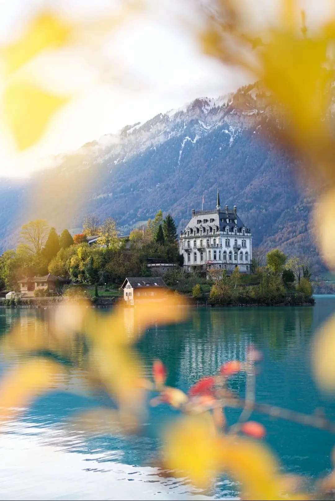 large house on a lake with mountains in the background, Vierwaldstattersee
