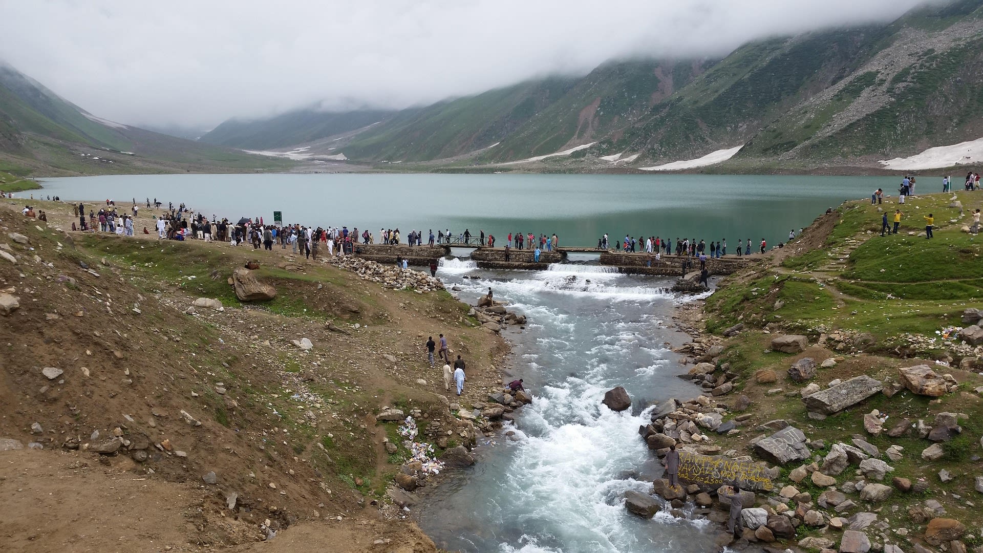 Brilliant blue waters of Lake Saiful Malook surrounded by snow-dusted peaks in Kaghan Valley, Pakistan