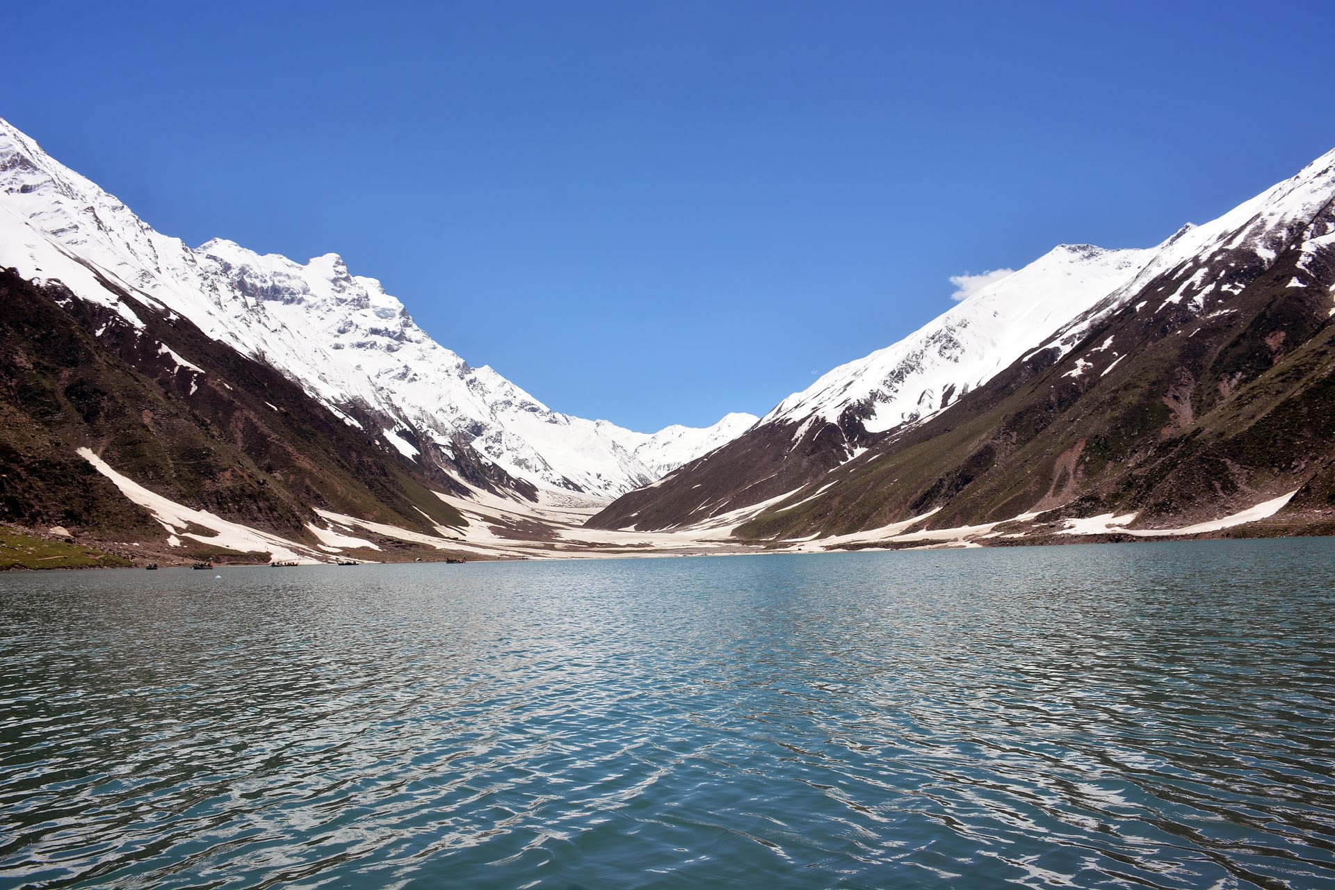 Snow-dusted shores and turquoise waters of Lake Saiful Malook in early season, Pakistan