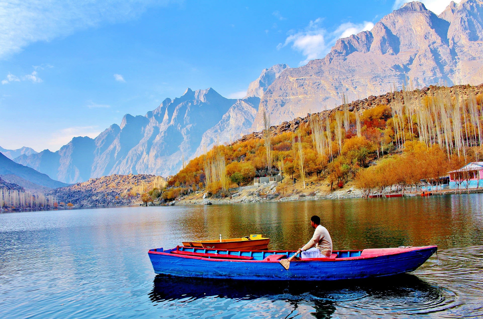 Golden autumn foliage of trees lining the shore of Lake Shangrila near Skardu, Pakistan
