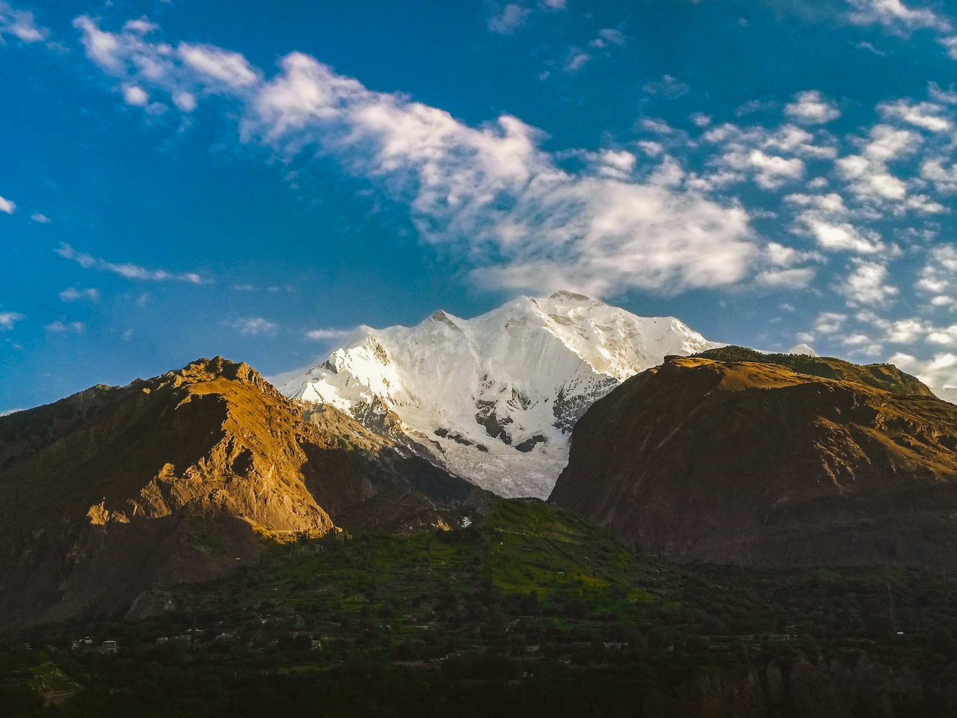 Majestic snow-covered summit of Rakaposhi rising above the Hunza Valley, Pakistan