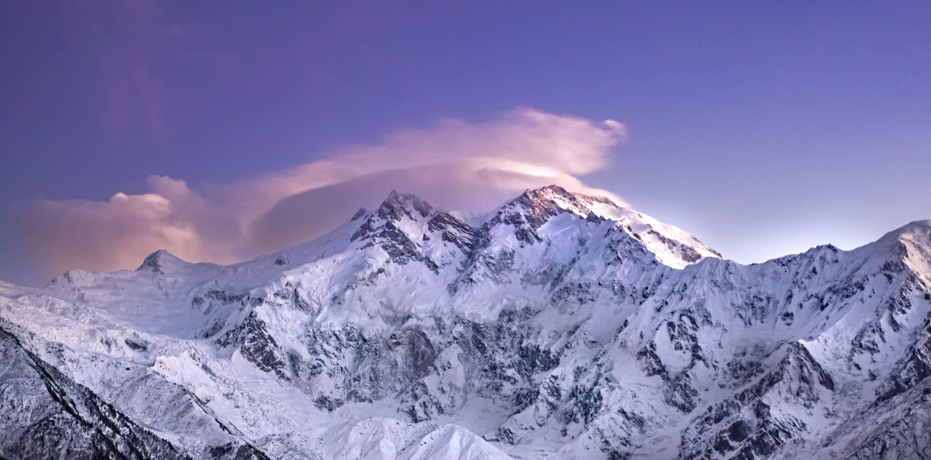 Lush green Fairy Meadows with Nanga Parbat's glaciated flanks dominating the skyline, Pakistan