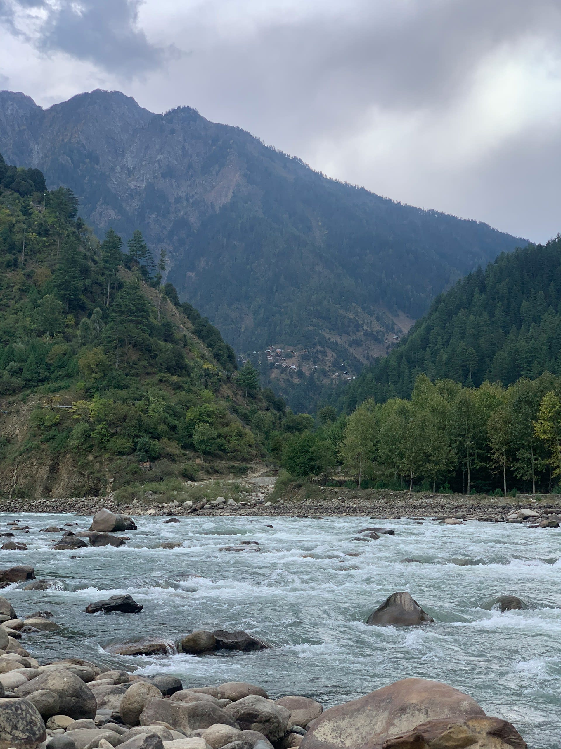 Lush green hills and winding Neelum River in Azad Kashmir, Pakistan