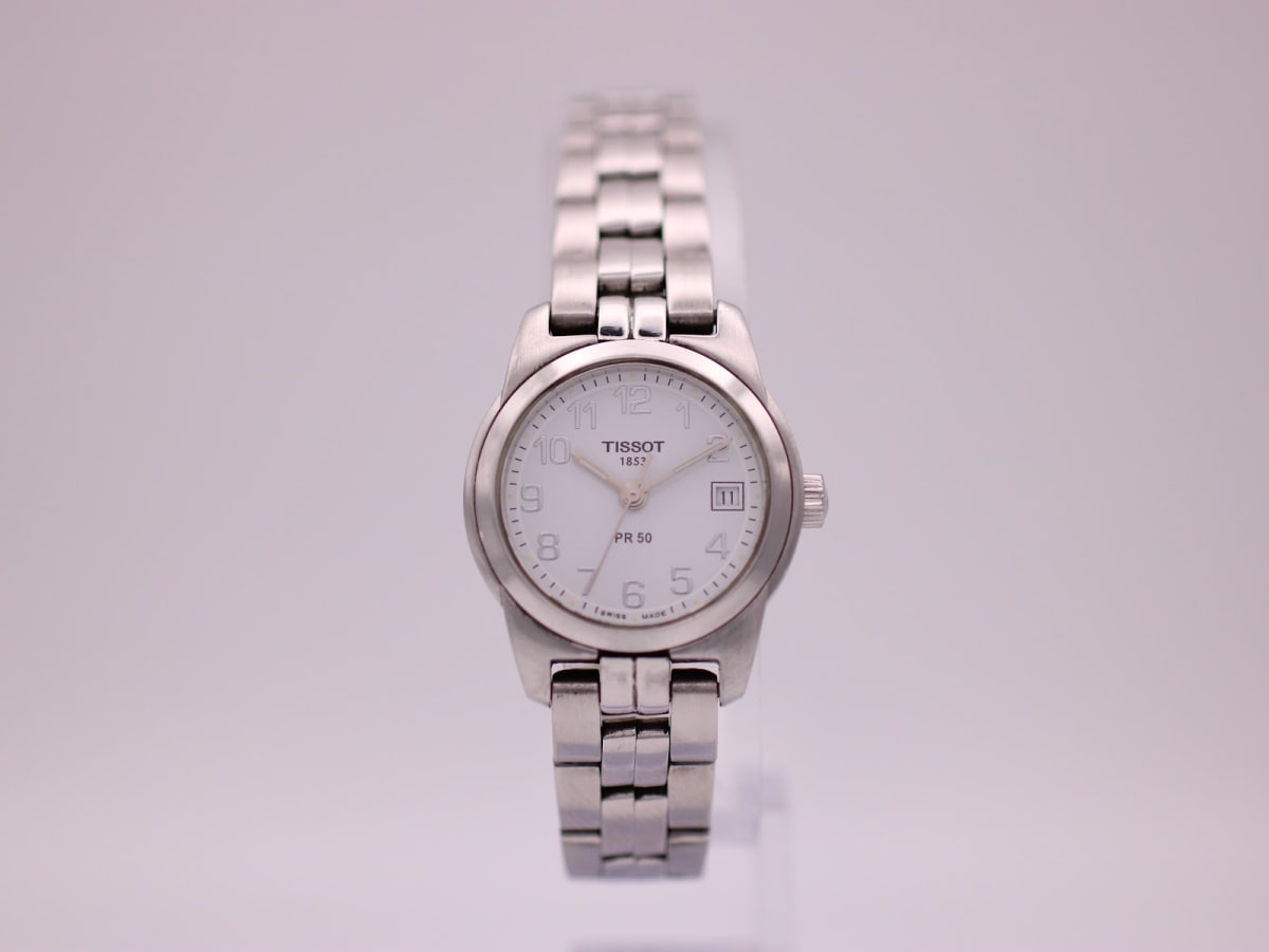 Front view of the Tissot PR 50 ladies quartz watch with a white dial and stainless steel bracelet.