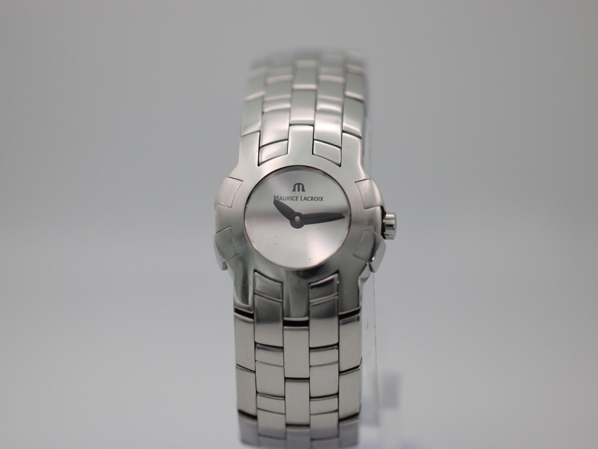 Front view of the Maurice Lacroix AE49679 ladies watch with a silver sunburst dial and integrated stainless steel bracelet, on a white background.