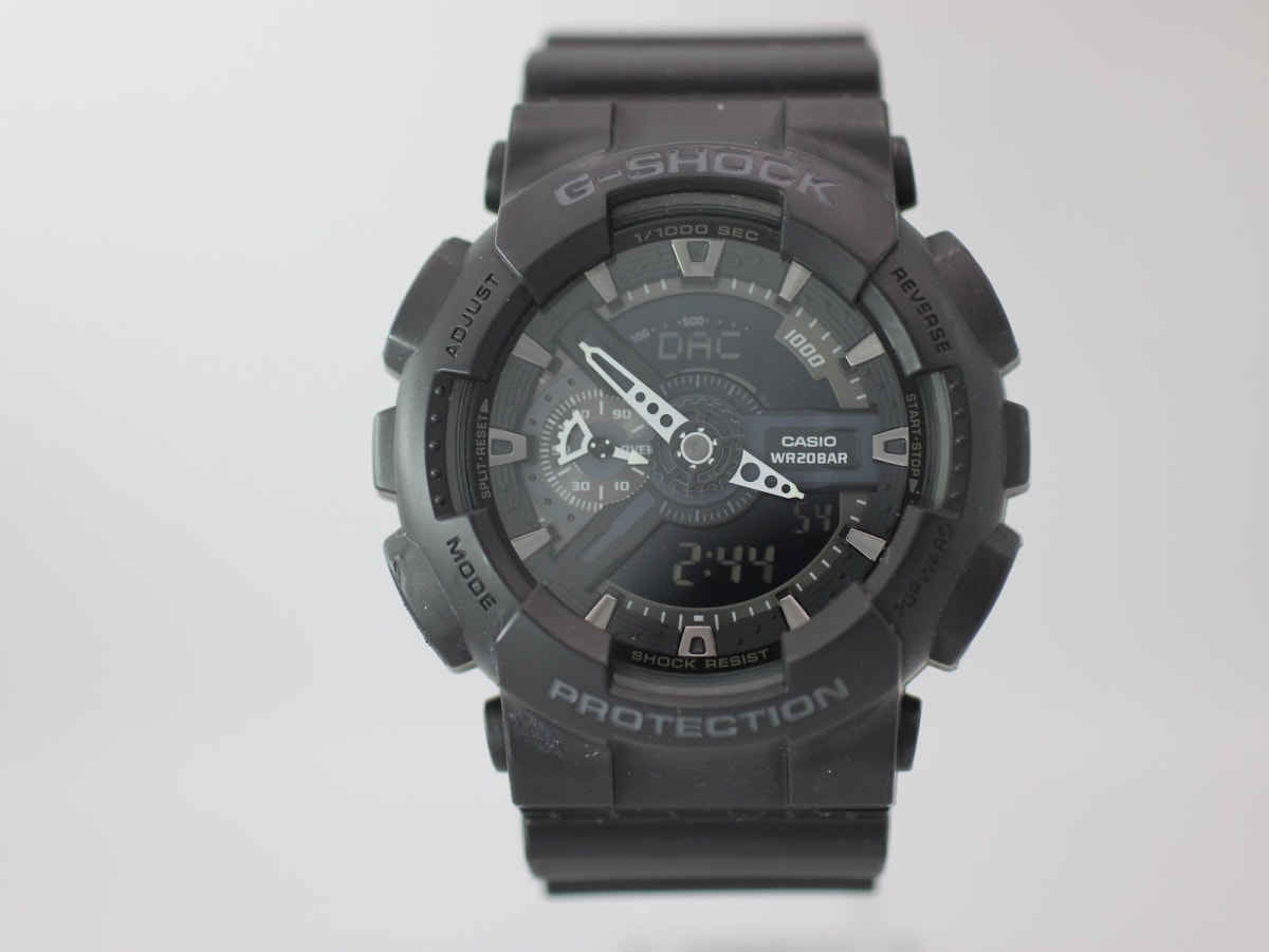 Front view of the black Casio G-Shock GA-110 ana-digi watch with white hands.