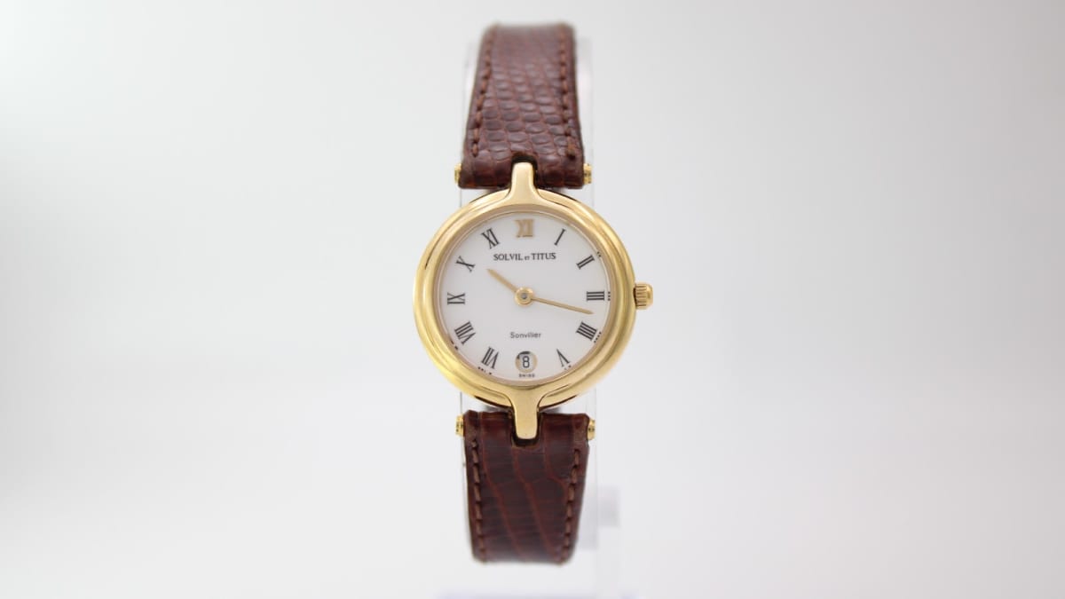 Front view of the Solvil et Titus Sonville quartz watch on a display stand, showing the full brown lizard effect leather strap.