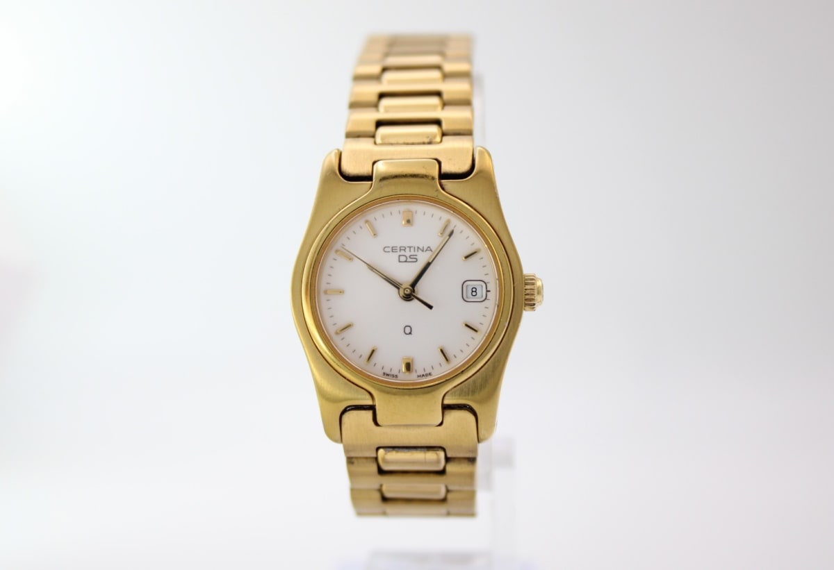 Front view of the Certina DS gold tone ladies watch with white dial and integrated bracelet, on a white background.