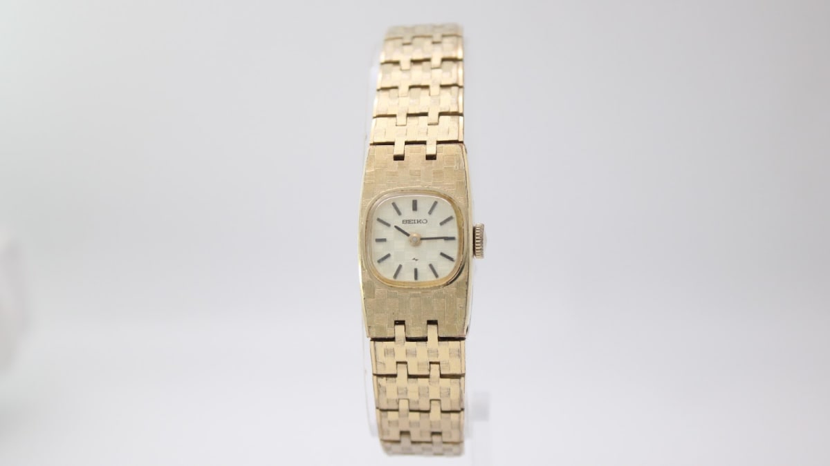 Front view of the gold-toned Seiko 11-3390 ladies' manual wind watch with a textured bracelet.