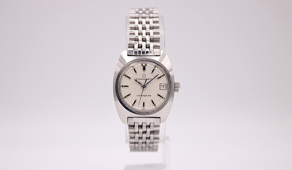 Front view of the Eterna Concept 80 automatic watch with cream dial, steel case, and multi-link bracelet.