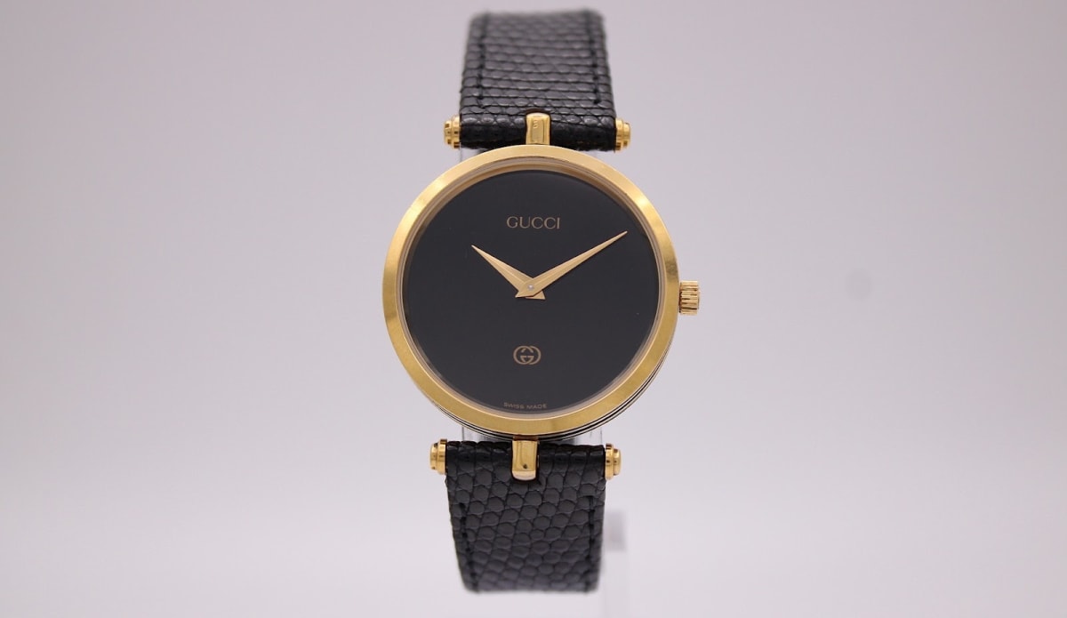 Gucci watch with black dial and two-tone case, 1990s
