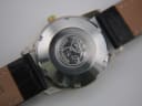 Close-up of the stainless steel case back with omega seamaster seahorse emblem.