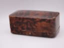 Closed view of the original brown faux tortoise shell presentation box for the Omega watch.