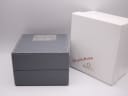 The exterior of the original grey Omega watch box alongside its white outer sleeve, with 'Significant Moments' text.