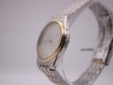 Side view of the Omega De Ville showing the slim case profile, crown, and two-tone bracelet.