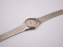 Full length view of the Omega De Ville two-tone bracelet and watch head on a white background.