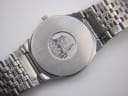 Close-up of the brushed stainless steel case back with the iconic De Ville building emblem and 'De Ville QUARTZ' text.