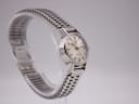 Angled view of the Omega Ladymatic on a stand, highlighting the bracelet's intricate ladder link design.