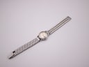 Top-down view of the Omega Ladymatic watch with its stainless steel bracelet extended, against a white background.
