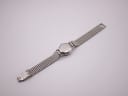 Rear view of the Omega Ladymatic watch with its case back and extended stainless steel bracelet.