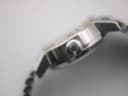 Extreme close-up of the watch's side, featuring the Omega-signed crown with the Greek letter Omega symbol.