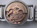 Macro shot of the Omega automatic movement with its rotor, bridges, jewels, and 'OMEGA WATCH Co SWISS ADJUSTED TWENTY-FOUR 24 JEWELS' text.