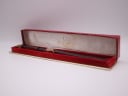 The Omega De Ville watch presented inside its original red Omega presentation box.