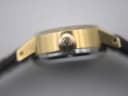 Close-up side view of the Omega De Ville crown, signed with the iconic Omega logo.