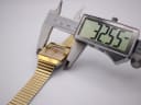 Digital caliper measuring the Rado Diastar watch case at 32.55mm.