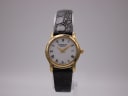 Front view of Raymond Weil 5360 watch with gold case, white dial, roman numerals, and black leather strap.
