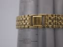 Close-up of the Seiko watch's gold-tone integrated bracelet and "SEIKO" signed clasp on a wrist sizing gauge, showing a wrist circumference of approximately 18.5cm.