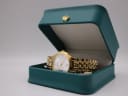 The Seiko gold-tone watch resting inside its original teal presentation box with a gold crown emblem.