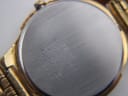 Macro shot of the Seiko watch case back, detailing engravings including "SEIKO WATER RESISTANT ST. STEEL + BASE METAL V732-0450".
